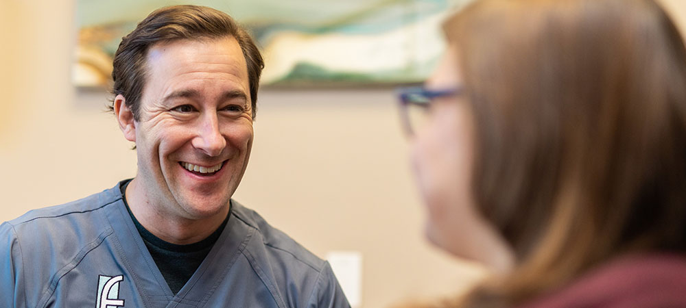 Dr. Ficca speaking to a female patient